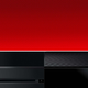 A black Xbox One console lays flat against a red background.